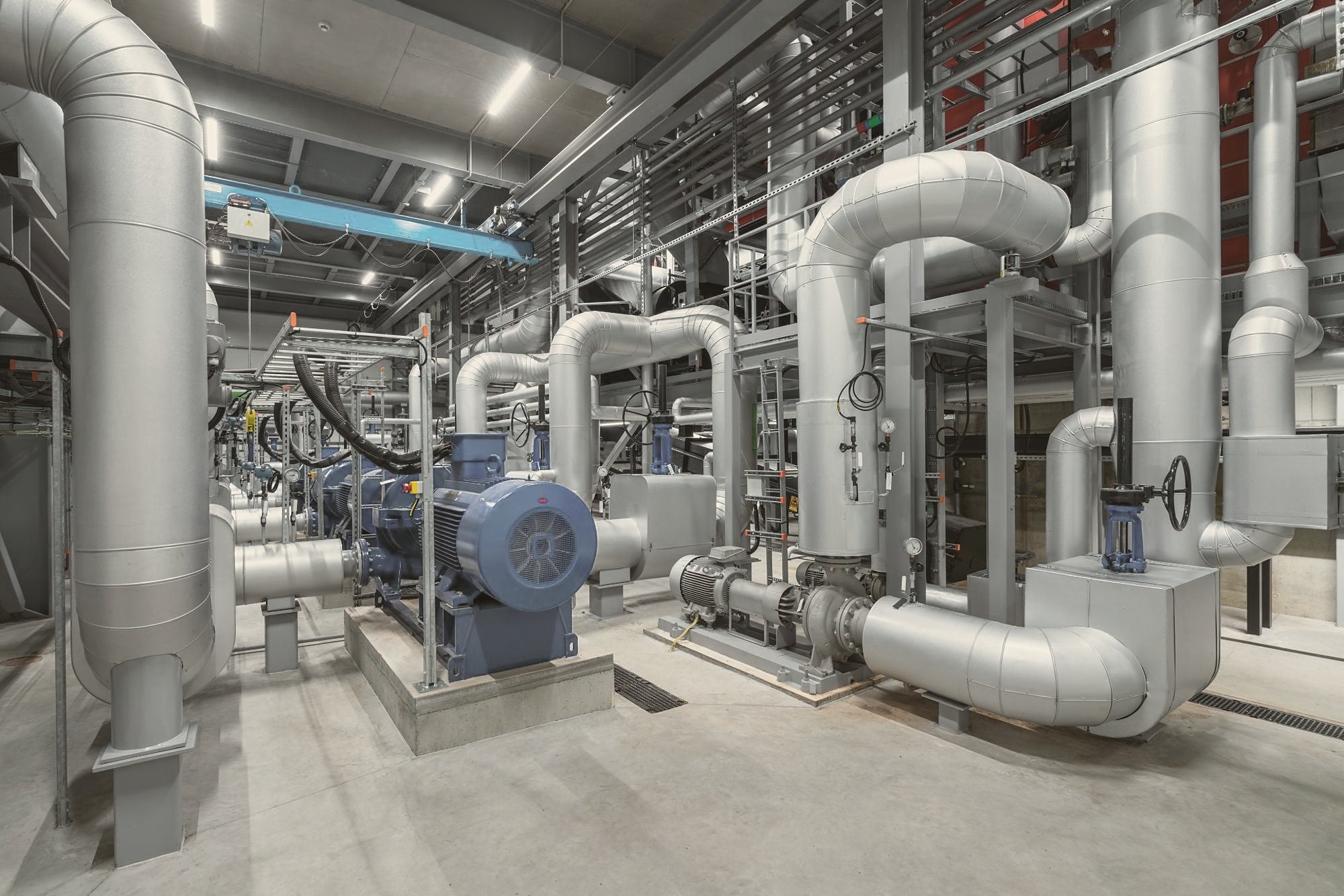 Pumps and insulated pipework in a building plant room